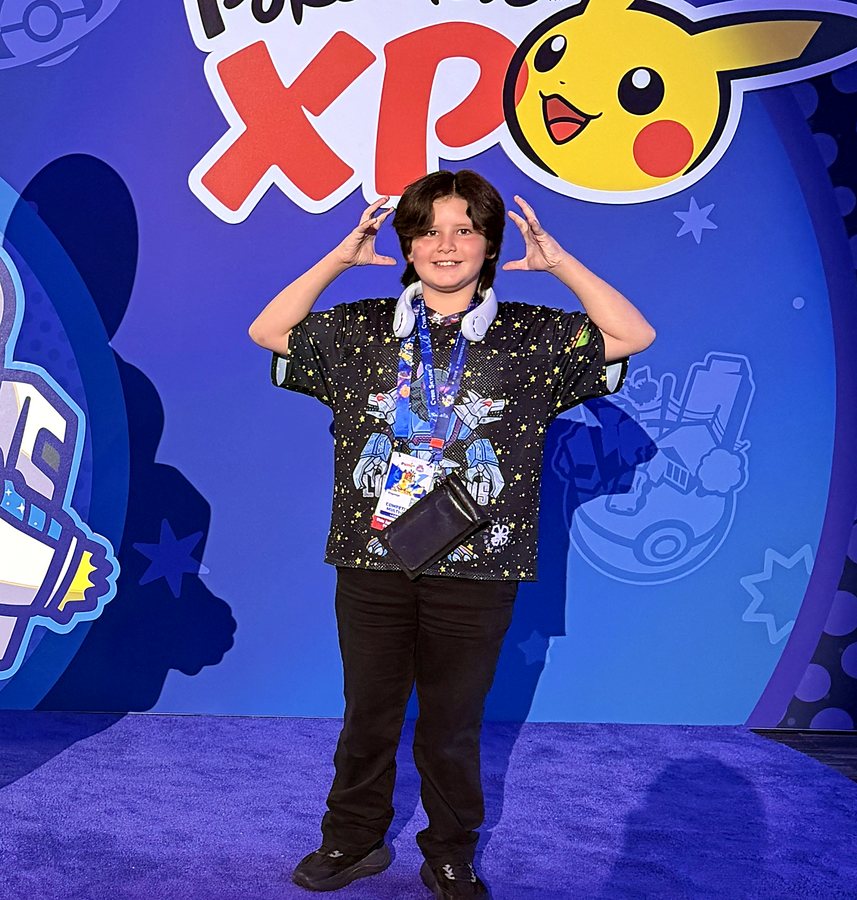 Dragoneye Duke with his hands up like horns on the Pokémon XP stage at Worlds 2026